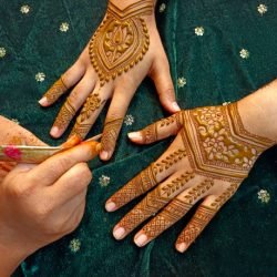 Mehndi artist making mehndi bridal hand In India, mehndi design.